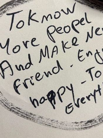 Handwritten note with the text: 'To know more people and make new friends. Enjoy happy to share everything.'