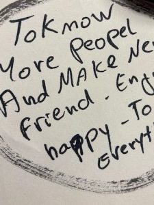 Handwritten note with the text: 'To know more people and make new friends. Enjoy happy to share everything.'